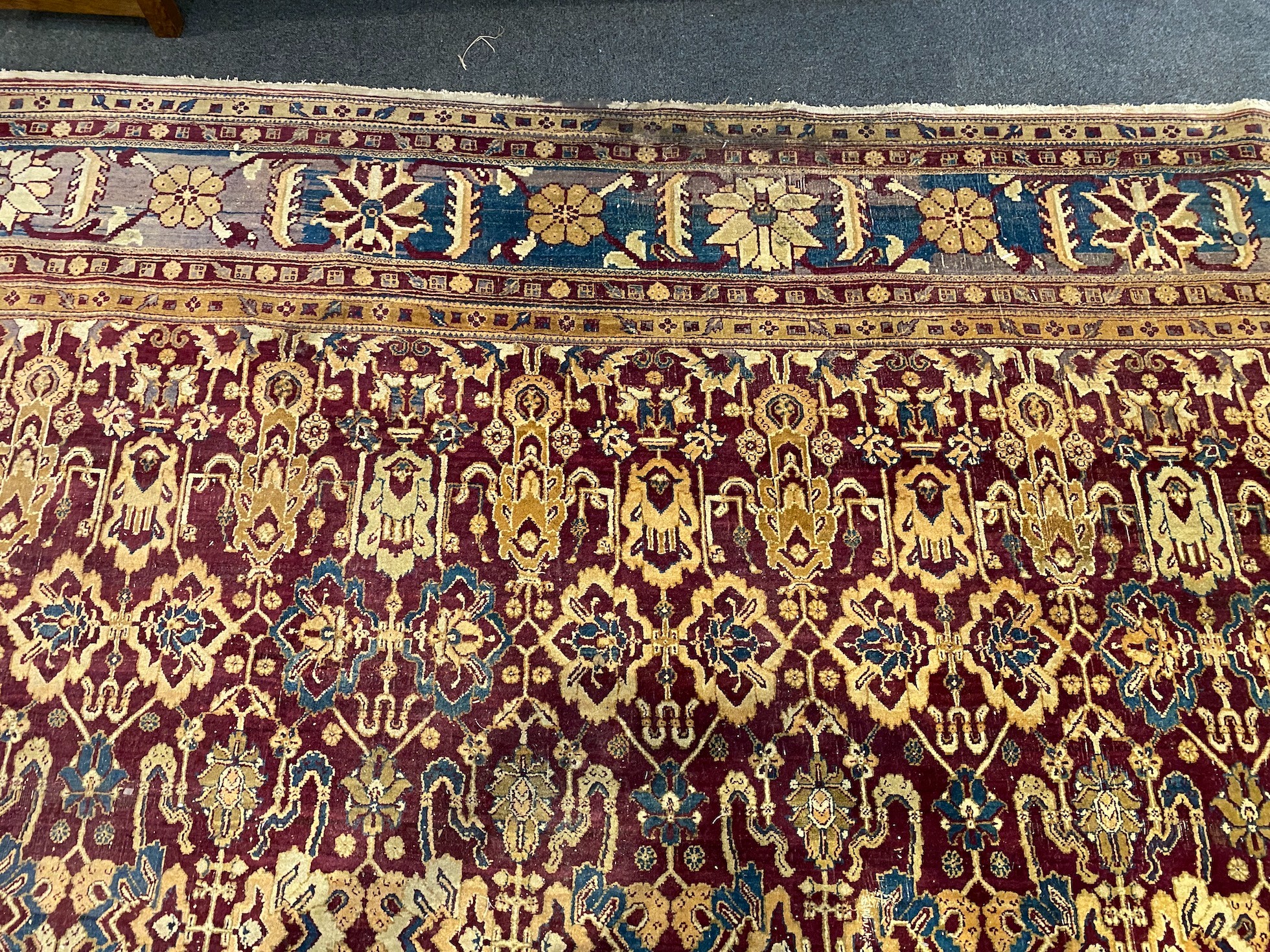 A large Sarouk purple ground carpet, approx. 20ft x 12ft. (cut in one area)